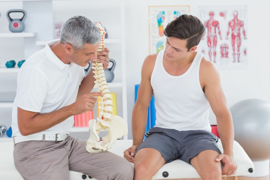 Texas pain specialist discusses back pain with patient.