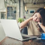 Woman with stiff neck pain